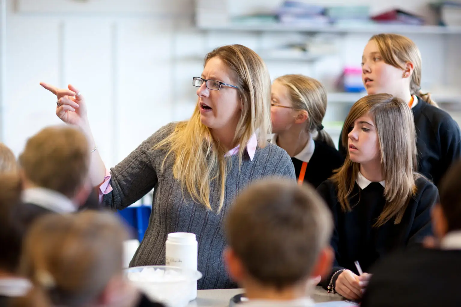 Female,Teacher,Helping,High,School,Students,In,Classroom,Lesson