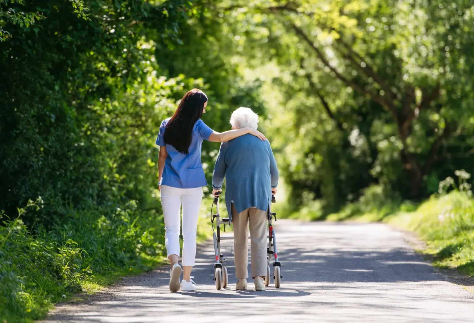 Female,Caregiver,And,Senior,Woman,With,Walker,On,Walk,In