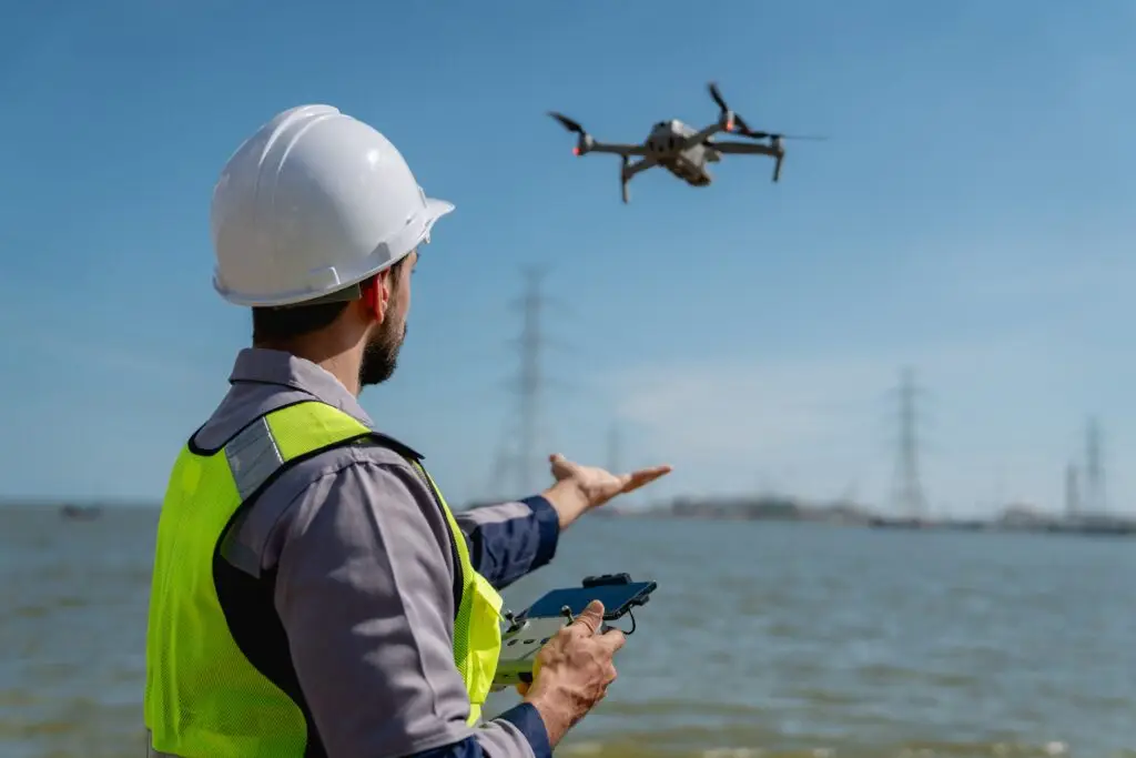 Engineer,In,A,Safety,Vest,Operating,A,Drone,To,Inspect