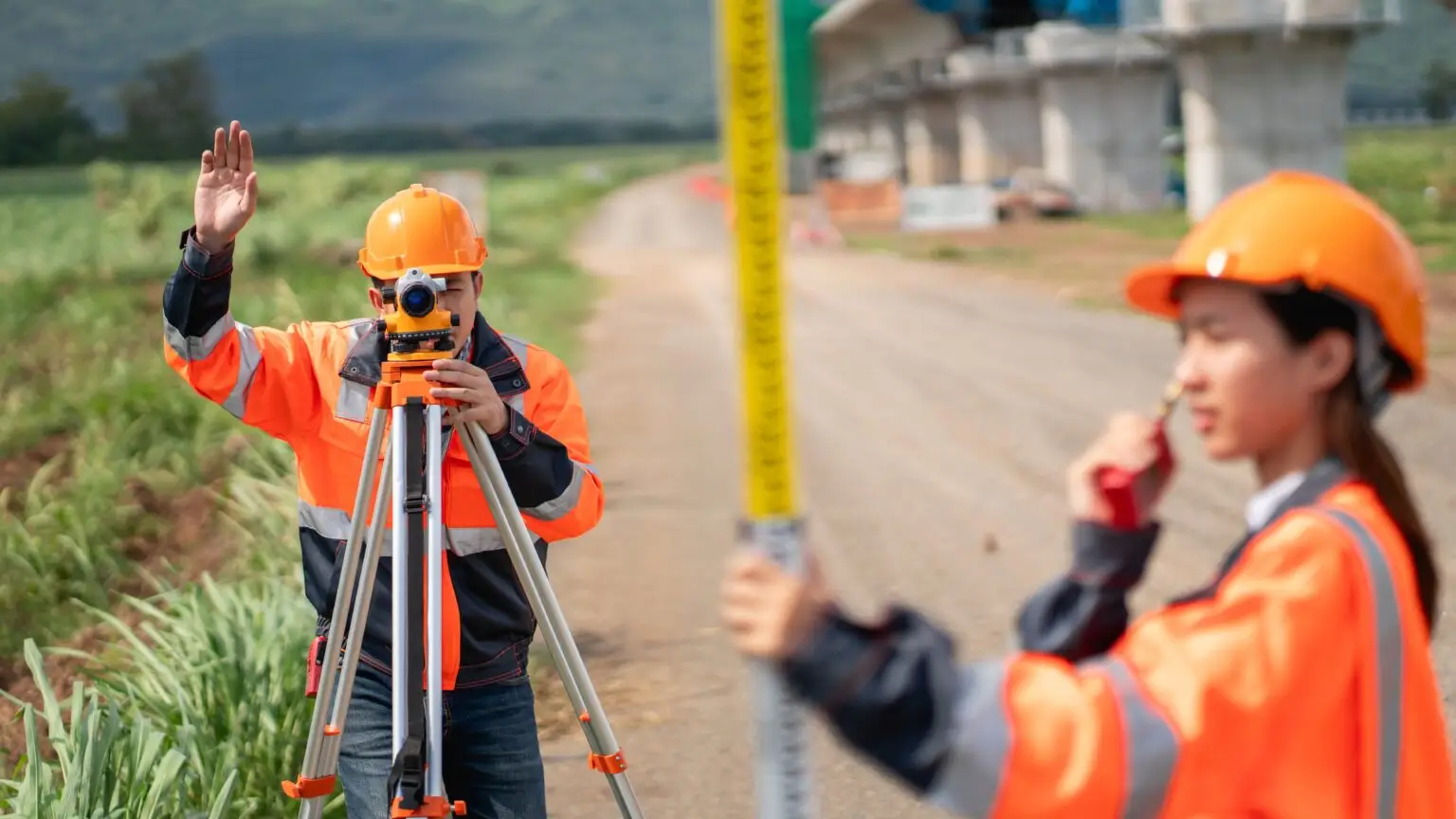 The,Survey,Team,Is,Using,A,Theodolite,And,Road,Construction