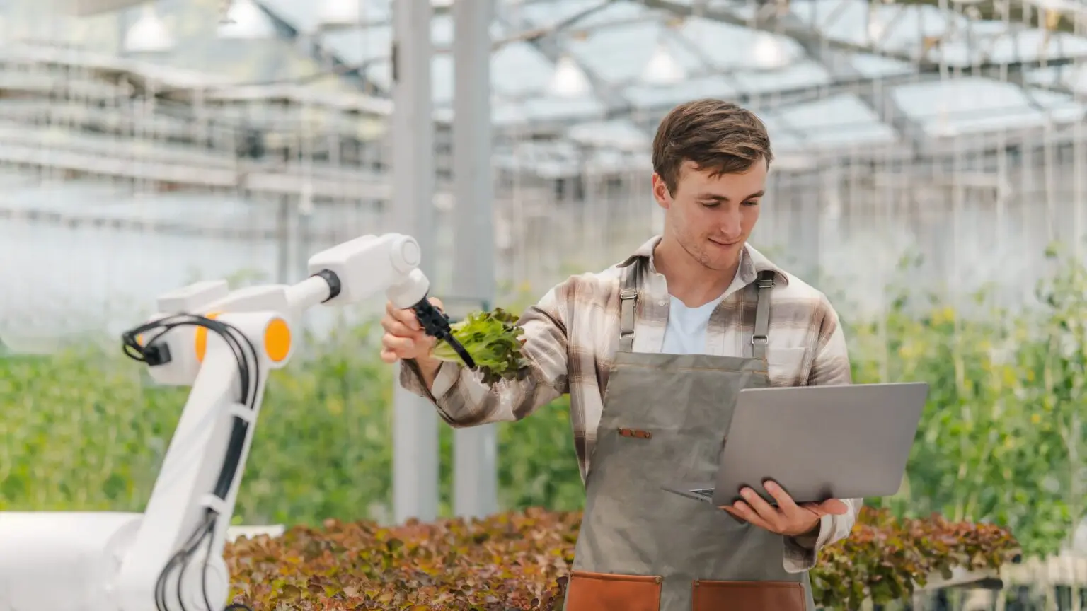 Male,Farmer,Using,Laptop,In,Greenhouse,To,Check,The,Operation